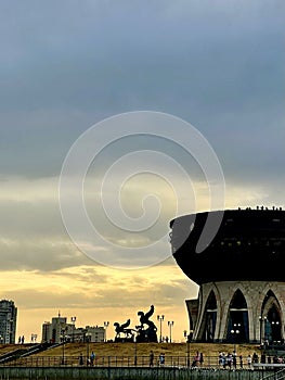 Wedding Palace or Bowl and silhouette of Zilant statues at sunset, Kazan, Russia