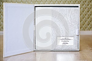 Wedding photo book with leather combined cover and metal shield