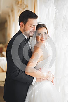 Wedding photo shoot of the newlyweds couple posing in a beautiful hotel