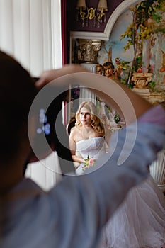 Wedding photographer is shooting portrait of the bride