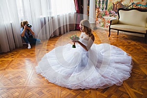 Wedding photographer is shooting portrait of the bride