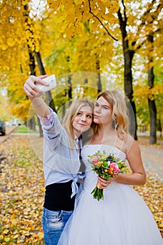 Wedding photographer shooting a selfie with the bride