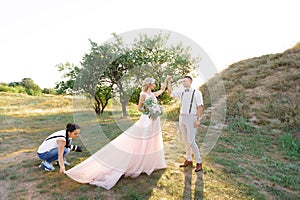 Wedding photographer takes pictures of bride and groom