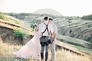 Wedding photographer takes pictures of bride and groom