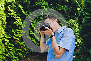 wedding photographer takes pictures of bride and groom in city. wedding couple on photo shoot. photographer in action.