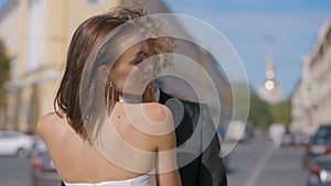 Wedding photography. Action. A beautiful couple of newlyweds in summer-style wedding suits pose with love