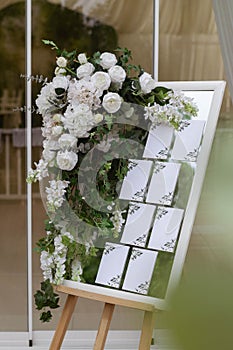 Wedding Photography: Classic Seating Chart on a White Wooden Frame, copy space