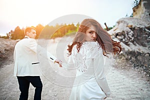 Wedding photosession of young couple near forest