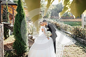 Wedding portrait. The groom in a black suit and the blonde bride in a white dress