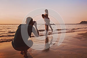 wedding portrait photographer taking photos of honeymoon couple on the beach