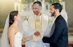 Wedding, priest and couple holding hands in church for a christian marriage oath and faithful commitment. Trust, bride