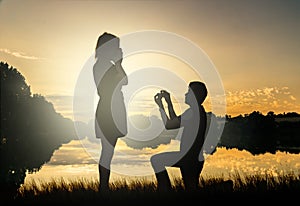 Wedding proposal concept. Young couple have dating at sun set.