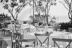Wedding reception dinner table setting with folding lawn chairs in Black and White
