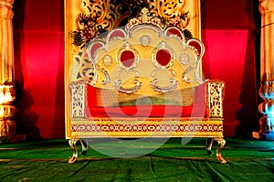 Wedding reception stage decoration with golden chair