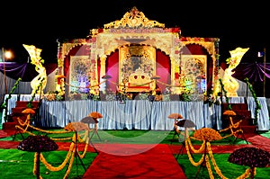 Wedding reception stage decoration with golden chair