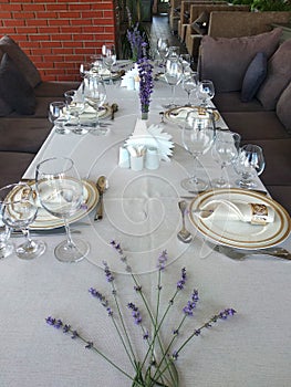 Wedding reception table with crockery, cutlery, glassware