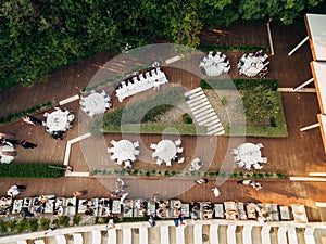 Wedding Reception Table Setting, dinner by the sea aerial top view. Guests at the wedding banquet sit at the table, the