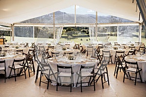 Wedding reception with tables and chairs adorned with white tablecloths