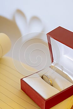 Wedding ring and abstract heart background, the concept of love and marriage.