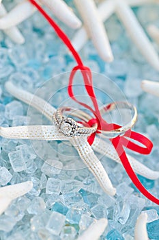 Wedding ring and band on a sea star