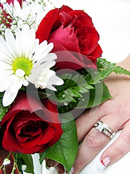 Wedding ring and bouquet closup