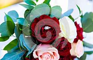Wedding ring on a bouquet of roses photo