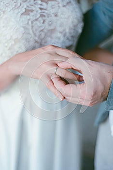 wedding ring on the finger. The groom puts the ring on the bride. wedding