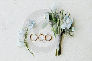 Wedding ring and flowers lay flat