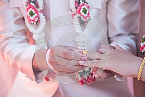 Wedding ring.Groom put the wedding ring on bride.Thai traditional wedding ceramony decoration