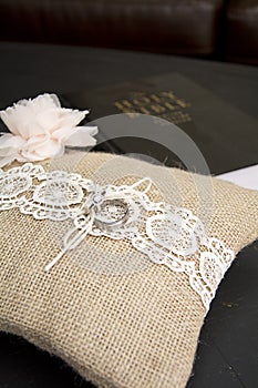 Wedding ring on pillow with bible