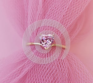 wedding ring with pink sapphire on a pink background