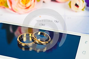 Wedding ring on screen of smart phone love