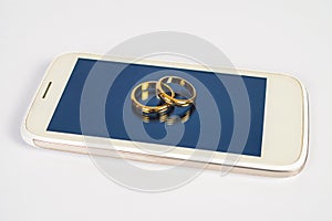 Wedding ring on screen of smart phone love