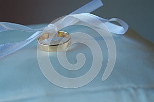 A Wedding Ring tied on a pillow.