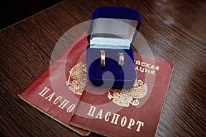 Wedding ring. Two gold vintage rings of the bride and groom are in a blue velvet box and a passport of the Russian Federation