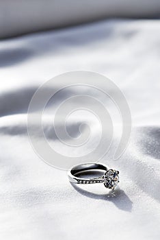 Wedding ring on white fabric