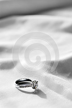 Wedding ring on white fabric