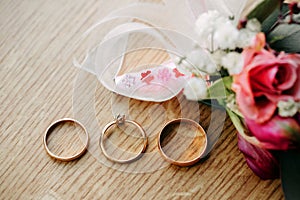 Wedding rings arranged on the wooden table.