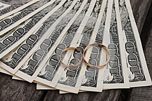 Wedding rings on the background of money