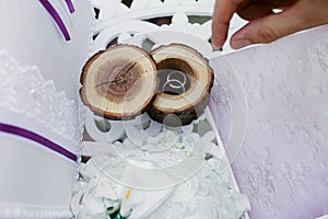 Wedding rings in a beautiful and stylish wooden box. The concept of a wedding, the ceremony of betrothal.