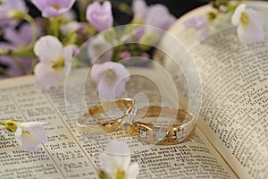 Wedding rings, Bible and flowers