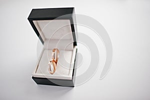 Wedding rings on black box on white background.