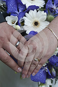 Wedding rings and bouquet of flowers