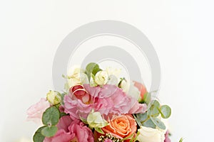 Wedding rings on the bouquet with flowers roses on a white background with copy space. minimal concept. mockup