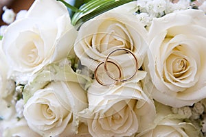 Wedding rings on a bouquet of roses