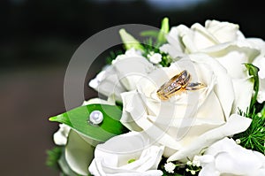 Wedding rings on a bouquet of white flowers