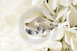 Wedding rings on a bouquet of white flowers