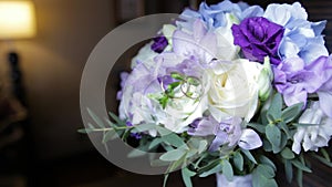 Wedding rings on a bouquet of white flowers. wedding rings and bouquet of dark blue flower. Close up. Wedding