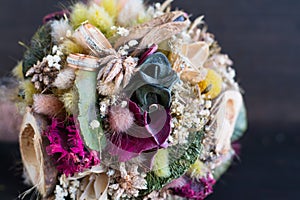Wedding rings on the bouquet of wild flowers