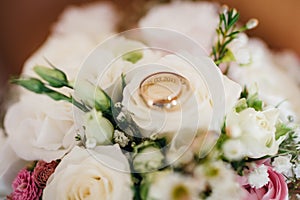 Wedding rings on a bridals bouquet